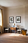 Interior of room with murals, chairs, basket and lamp in Gutshaus Boldevitz, Germany