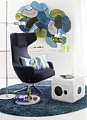 Armchair, cube shaped stools and floor lamp on grey carpet