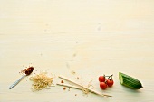 Zucchini, cherry tomatoes, chopsticks, noodles and spices on yellow background