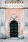 Entry door of winery castle with stone carving