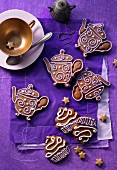 Decorated gingerbread biscuits shaped like teapots and cupcakes