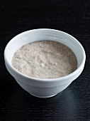 Yeast mixed with water in bowl for preparing bread, step 2