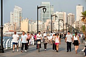 People strolling at corniche with street lights in background, Beirut, Lebanon