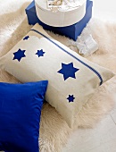 Beige pillow with star motif on white carpet