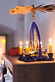 Christmas pyramid with candles on table