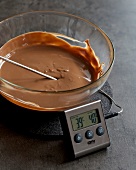 Temperature of melted chocolate in bowl being checked, step 3