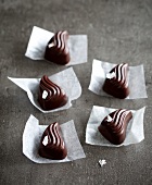 Nougat drops chocolate with sesame on wax paper