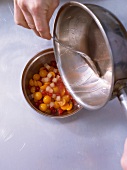 Sugar syrup being poured in rum pot vegetables