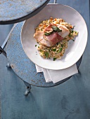 Zander saltimbocca with barley and root vegetable risotto on plate