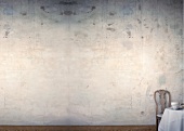 Rustic wooden chair against white wall