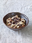 Bananas and chocolate cream in brown bowl