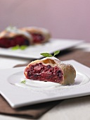 Blueberry strudel with limoncello sauce on plate