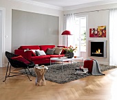 Living room with fireplace, red sofa, rug and table