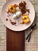 Lavender peaches with goat cream cheese and brittle pistachio on plate