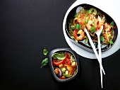 Thai noodle salad with shrimp and vegetable salad in two bowls