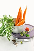 Fresh carrots in a cup with a strawberry and pepper