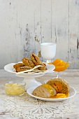 Chestnut croquettes on cake stand with yeast dumplings on plate