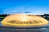 Woman in front of fountains at Royal Gardens in Herrenhausen Palace, Hannover, Germany