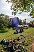 People relaxing at park at Weddige bank 29 in Linden, Hannover, Germany
