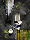 Watches, knives and fish, overhead view