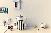 Cup of coffee, jar and lemon on table and calendar on wall