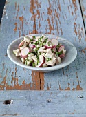 White sausage salad with radish on plate