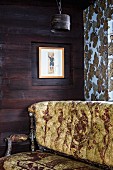 Unheated room with wooden walls & antique sofa