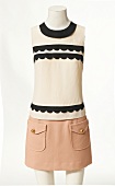 Sleeveless top and mini skirt on mannequin on white background