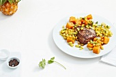 Rump steak with vegetables on plate