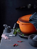 Different types of kitchenware with orange cooking pot