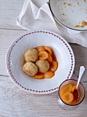 Apricot compote with vanilla and cardamom and dumplings in serving dish