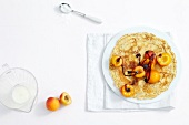 Poppy pancake with apricot on plate