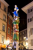 People sitting at sculpture near buildings in Lausanne, Canton of Vaud, Switzerland