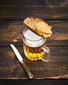 Bread slice with obatzda on mug of beer