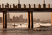 View of sea beach, pier and surfers at Durban, South Africa