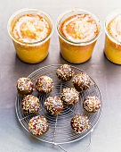 Orange cake in jar and chocolate cake balls on oven rack