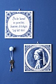 Decorative tiles on blue wall with keys