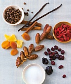 Spices and dried fruits on gray background