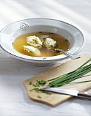 Vegetable broth with butter dumplings in bowl