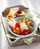 Mix fruit plate with bread slices in wicker tray