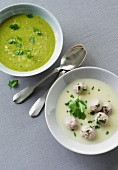 Pea soup and kohlrabi soup with meatballs in bowls
