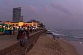 People at promenade in front of Galle Face Hotel at dusk, Colombo, Sri Lanka