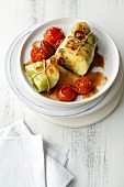 Cabbage rolls with tomatoes on plate