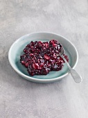 Fruit jam with marzipan and berry on plate