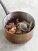 Cider, tea, egg and figs in saucepan for preparation of jam