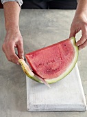 Close-up of peeling watermelon for preparation of jam