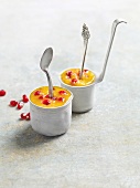 Close-up of cardamom and mango ice cream with pomegranate in cups