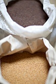 Close-up of bags with mustard seeds and flax seed