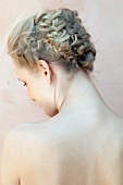 Rear view of blonde woman with braids pinned up