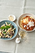 Two bowls of ground beef, ricotta and spinach noodles and spaghetti alla bolognese
